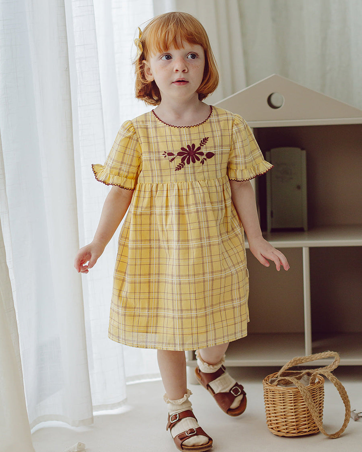 Happyology girl wearing a dress from the collection