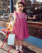 Happyology girl with a suitcase outside the studio